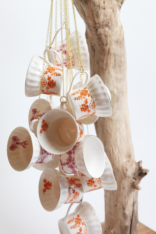 James Worsham | The Elites (detail) | teacups, gold plated chain, wood, iron | 43